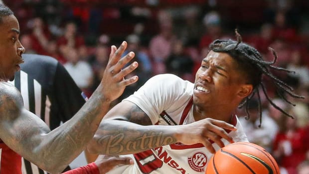 Razorback guard Khalif Battle getting knocked out of bounds against Alabama